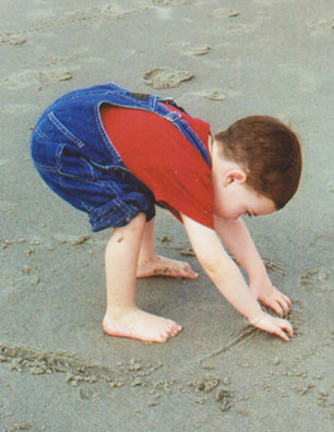 Wiley playing in the sand at Cocoa Beach