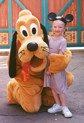 Autumn poses for a photo with Pluto.  She is soaked from going on the water ride 3 times